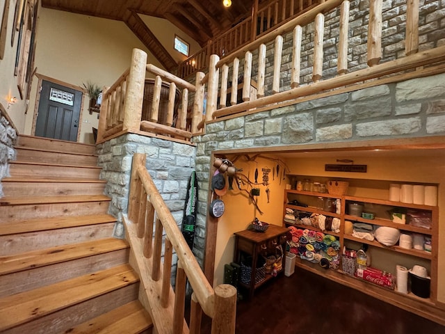 stairway featuring high vaulted ceiling