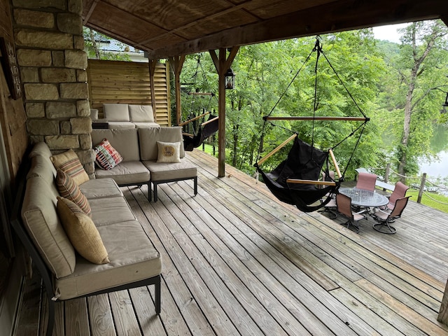 wooden terrace featuring outdoor dining space and outdoor lounge area