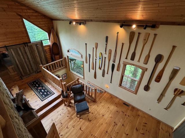 interior space with rail lighting, wood ceiling, visible vents, and wood finished floors