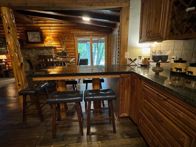 bar featuring rustic walls, vaulted ceiling with beams, and backsplash