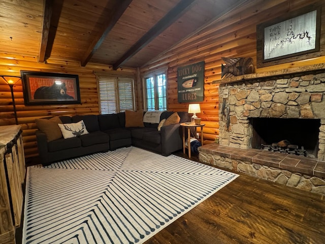 living area with vaulted ceiling with beams, a fireplace, log walls, and wood finished floors