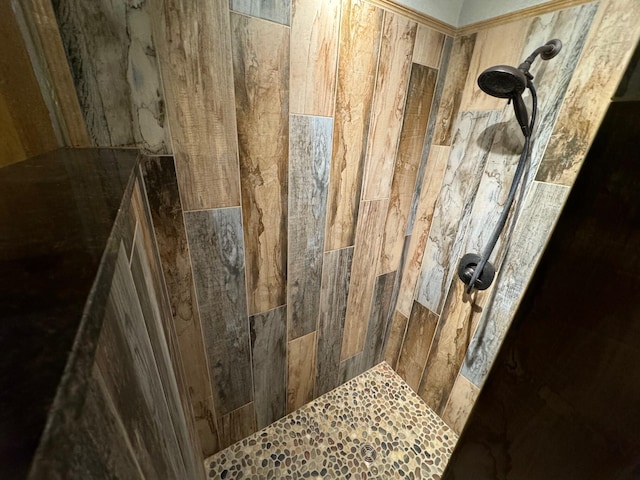 interior details with a tile shower