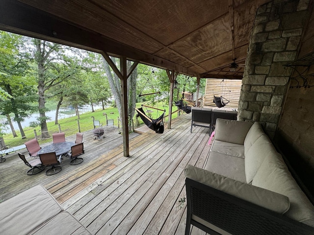 deck featuring outdoor lounge area, a water view, and a ceiling fan