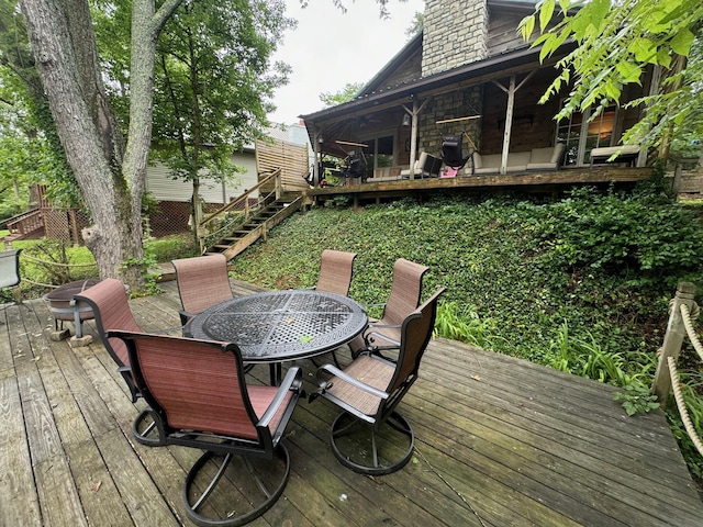 wooden terrace with stairway and outdoor dining area