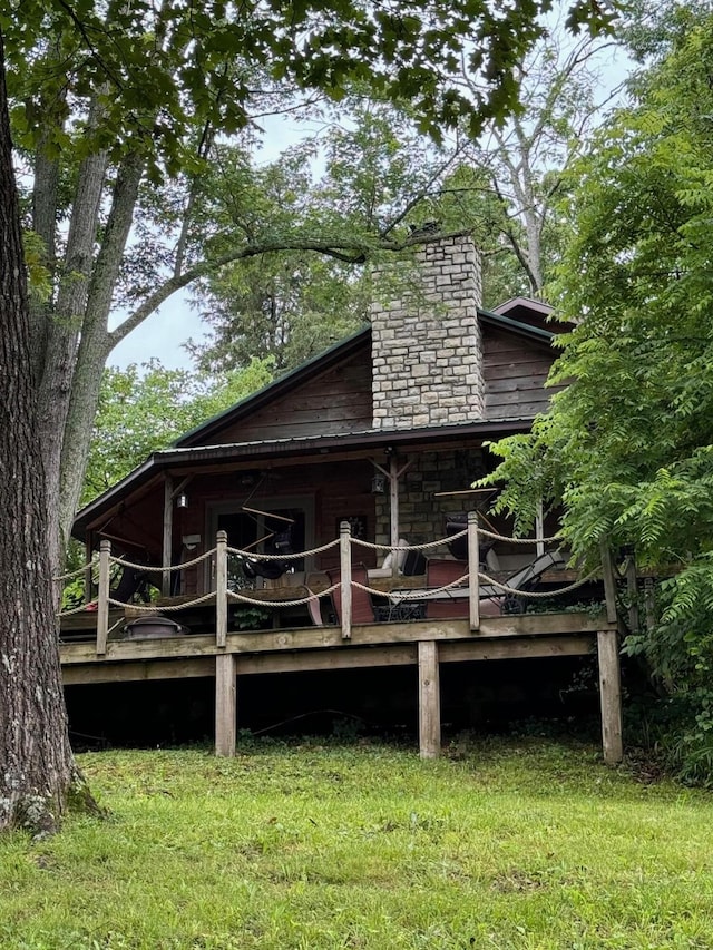 exterior space with a lawn and a wooden deck