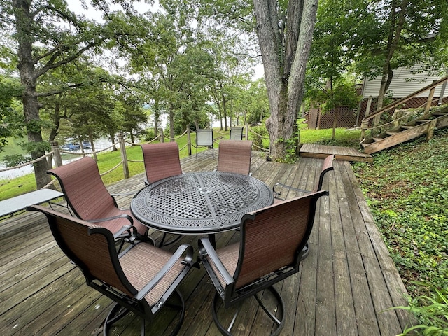 deck featuring outdoor dining space and stairs