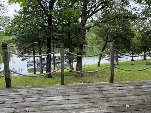 exterior space with a water view and a lawn