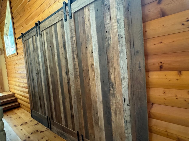 room details featuring rustic walls and a barn door