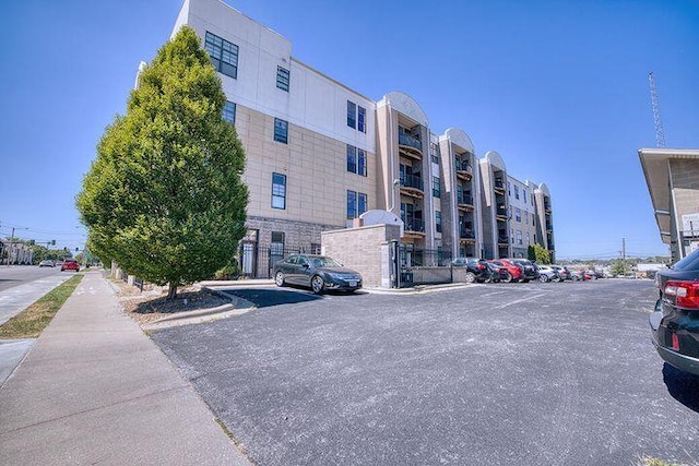 view of property featuring uncovered parking