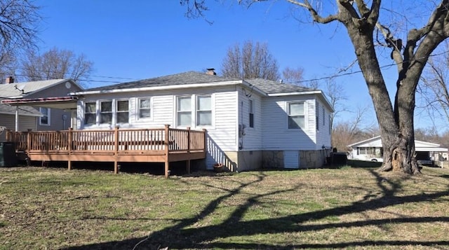 rear view of house with crawl space, a yard, and a wooden deck