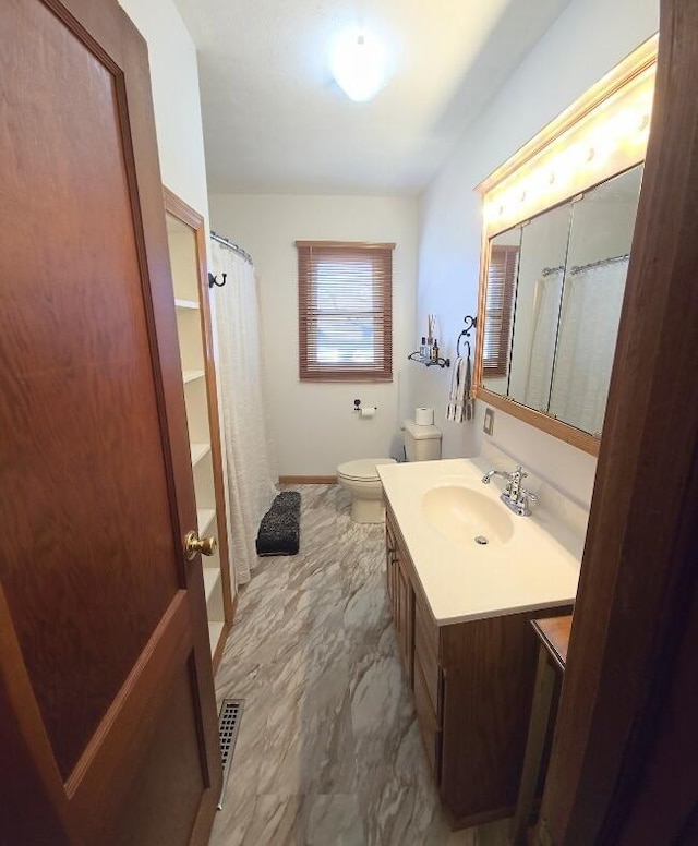 bathroom with visible vents, toilet, a shower with curtain, marble finish floor, and vanity