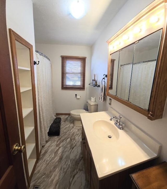 full bath with toilet, baseboards, and vanity