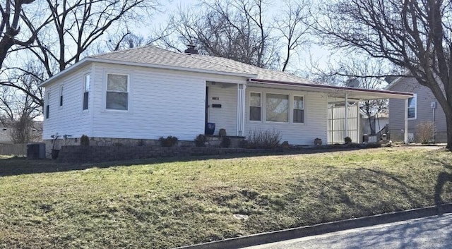 single story home featuring a shingled roof and a front lawn