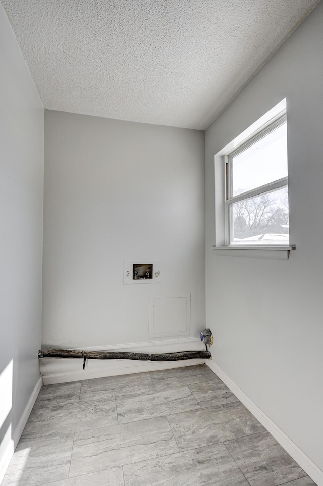 503 Chestnut St, Neosho, MO 64850 - clothes washing area with a textured ceiling, laundry area, washer hookup, and baseboards