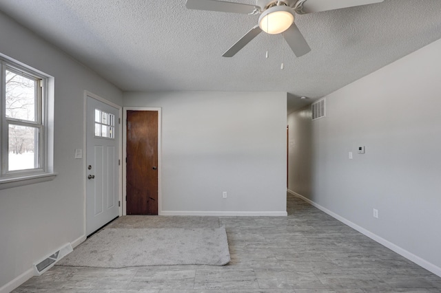 503 Chestnut St, Neosho, MO 64850 - foyer entrance featuring visible vents, a textured ceiling, and baseboards