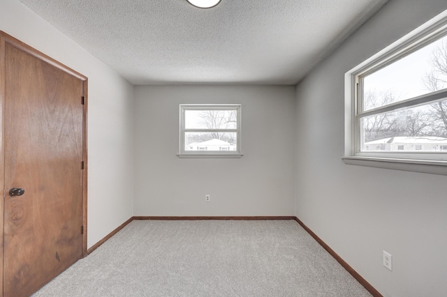 503 Chestnut St, Neosho, MO 64850 - unfurnished bedroom featuring baseboards, a textured ceiling, and light colored carpet