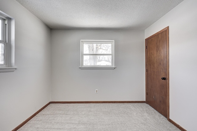 503 Chestnut St, Neosho, MO 64850 - empty room featuring light carpet, a textured ceiling, and baseboards