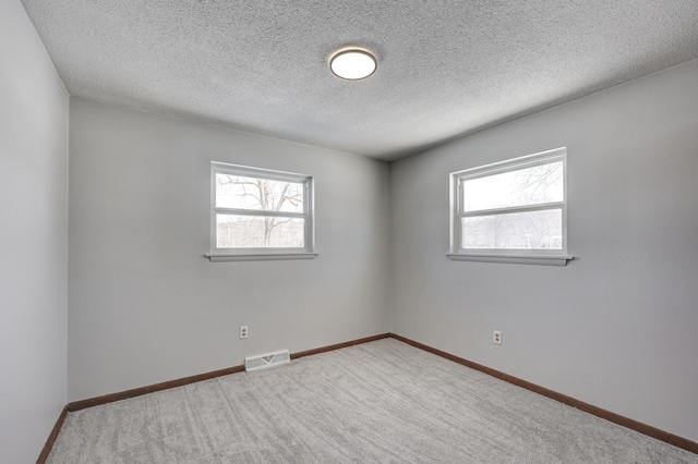 503 Chestnut St, Neosho, MO 64850 - empty room featuring a healthy amount of sunlight, carpet floors, baseboards, and visible vents