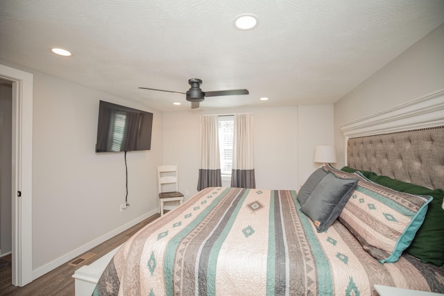 bedroom featuring recessed lighting, a ceiling fan, a textured ceiling, wood finished floors, and baseboards