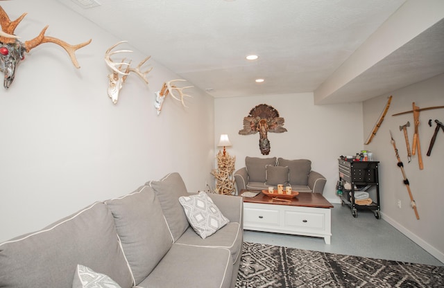 living room with baseboards, finished concrete floors, and recessed lighting