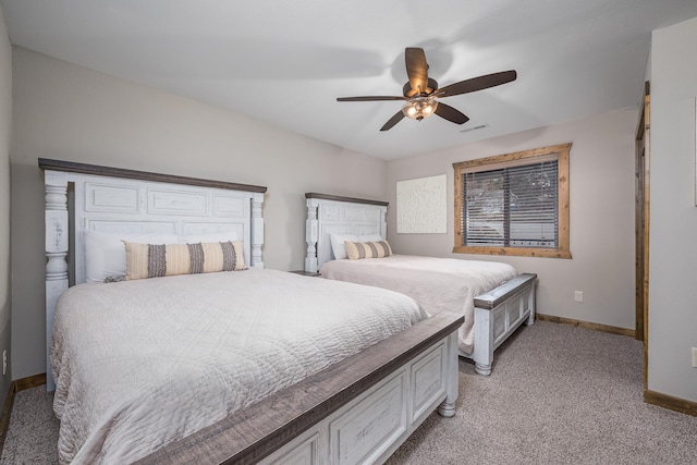 bedroom featuring a ceiling fan, baseboards, visible vents, and light carpet