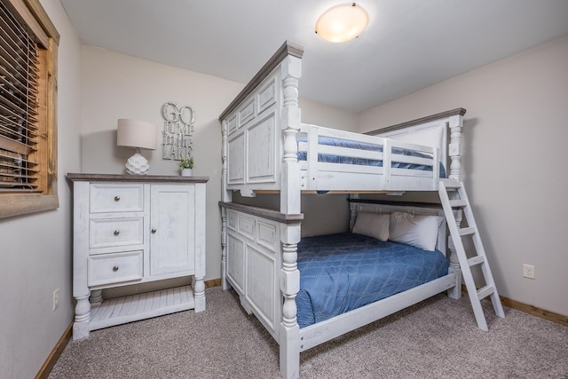 bedroom featuring carpet flooring and baseboards