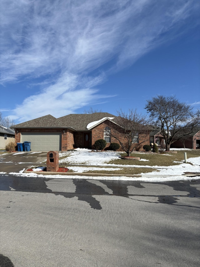 view of front of house with concrete driveway, a shingled roof, an attached garage, and brick siding