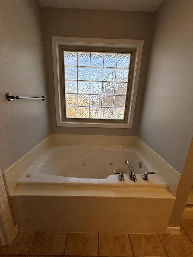 full bathroom featuring a jetted tub and a wealth of natural light