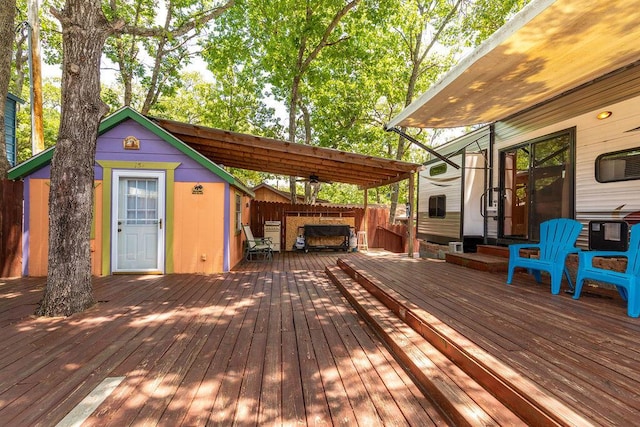 deck featuring a pergola and an outbuilding