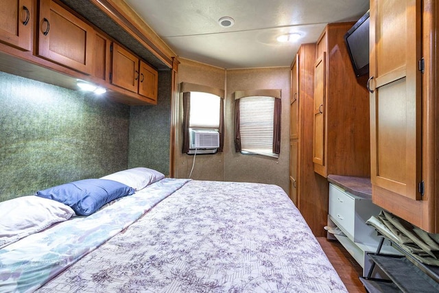 bedroom featuring dark wood-style flooring and cooling unit