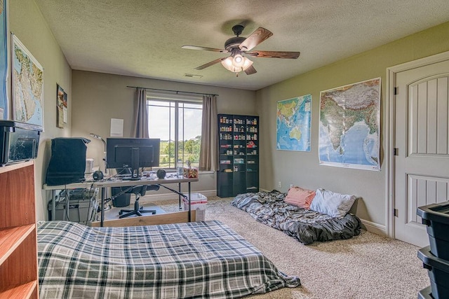 carpeted bedroom with a ceiling fan, visible vents, a textured ceiling, and baseboards