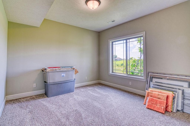 unfurnished bedroom featuring visible vents, light carpet, and baseboards