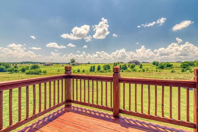 deck featuring a rural view and a lawn