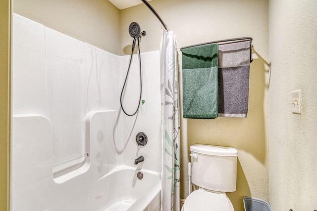 full bathroom with toilet and shower / bath combo with shower curtain