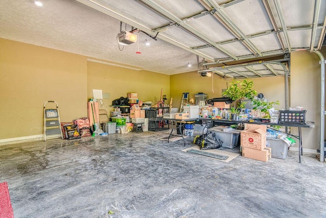 garage featuring baseboards and a garage door opener