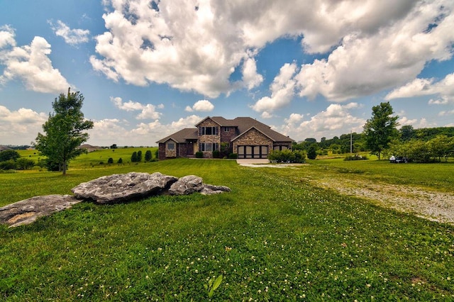 view of front of home with stone siding, a front lawn, and a rural view