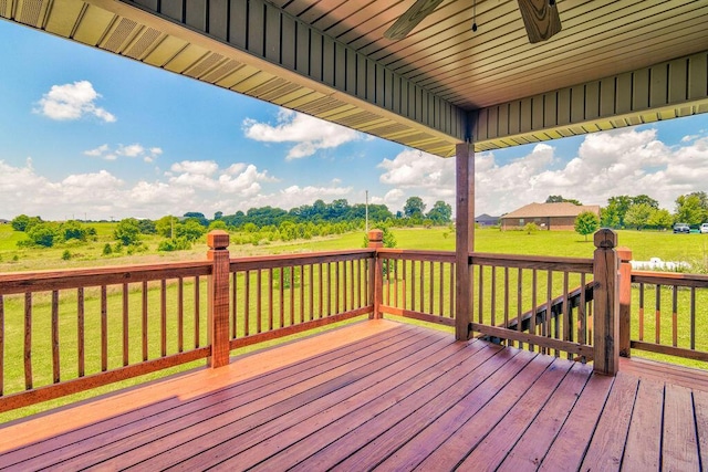 deck featuring a yard and a ceiling fan