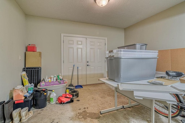 miscellaneous room featuring a textured ceiling and concrete floors