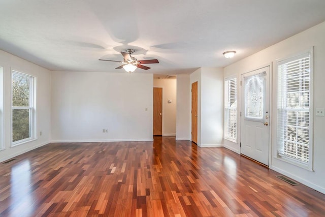 entrance foyer with baseboards, visible vents, and dark wood-type flooring