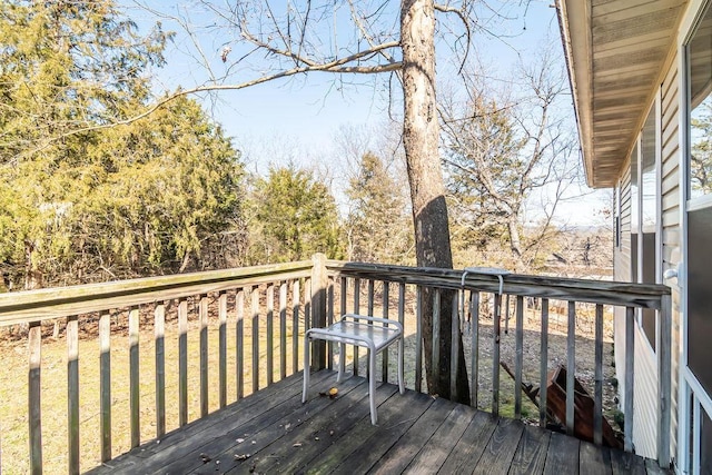 wooden deck featuring a yard