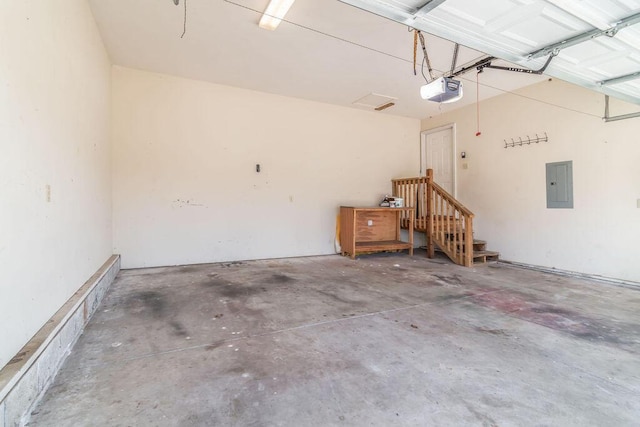 garage with electric panel and a garage door opener