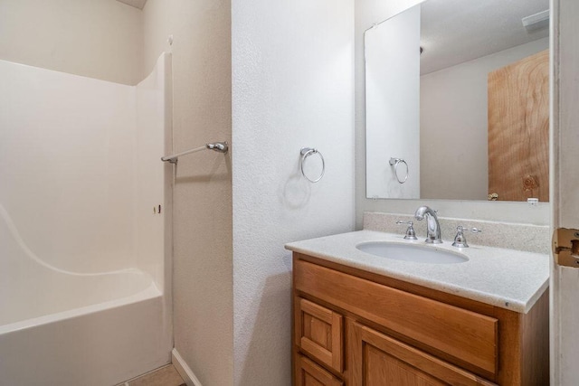 full bathroom featuring  shower combination, vanity, and tile patterned floors