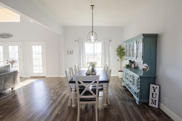 dining area featuring dark wood-style flooring, french doors, and baseboards