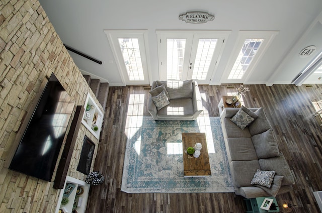 unfurnished living room with stairway, wood finished floors, beamed ceiling, and french doors