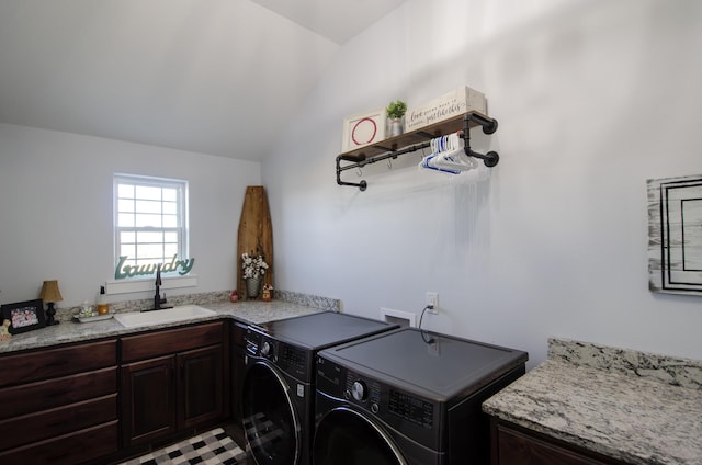 laundry area featuring cabinet space, a sink, and washing machine and clothes dryer