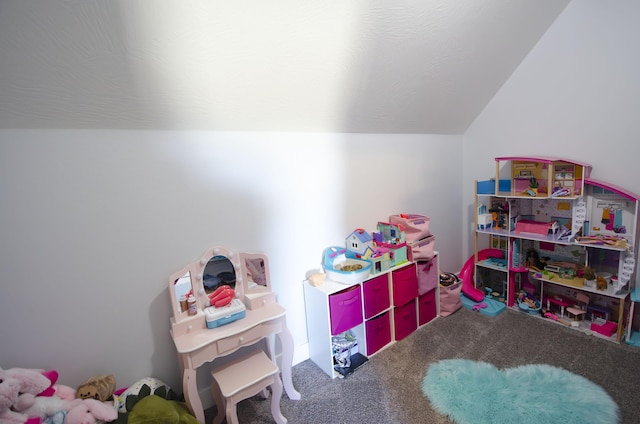 playroom featuring carpet and vaulted ceiling