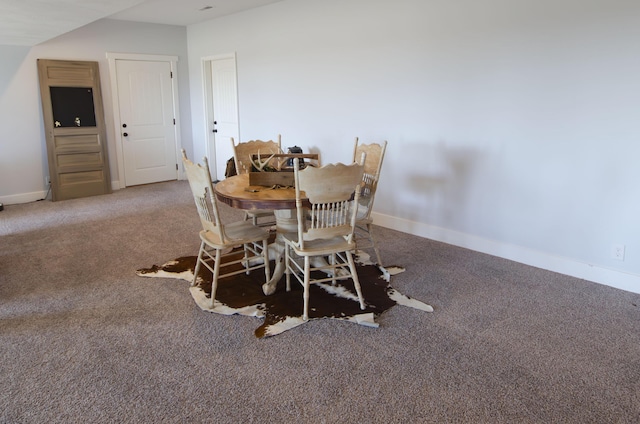 dining room featuring carpet and baseboards