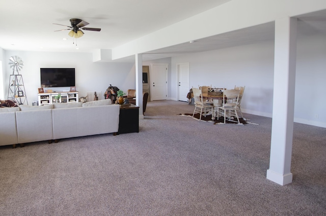 living room with carpet, ceiling fan, and baseboards