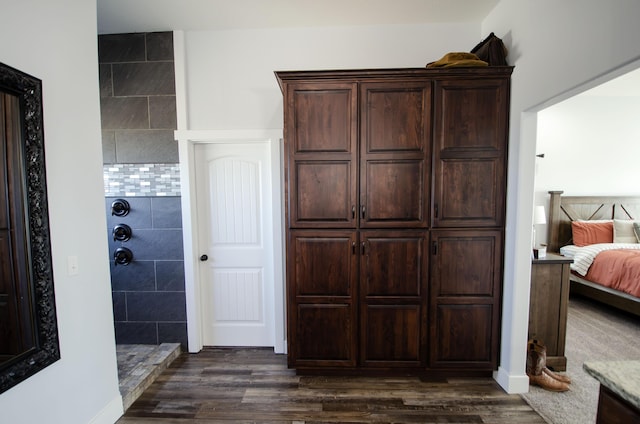 full bathroom featuring ensuite bathroom, a walk in shower, and wood finished floors