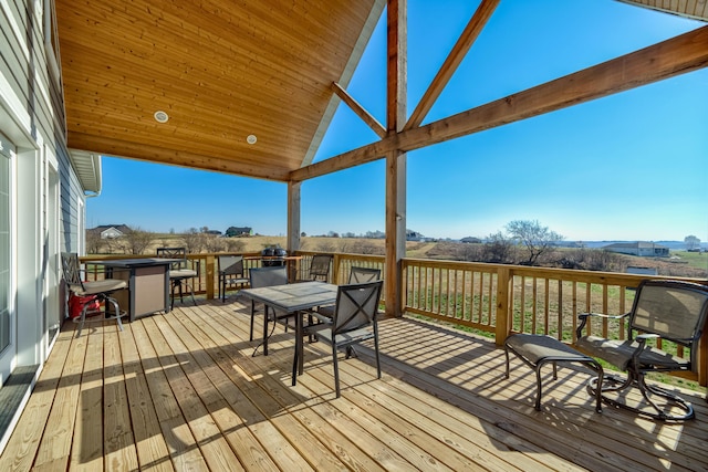 wooden deck featuring outdoor dining area